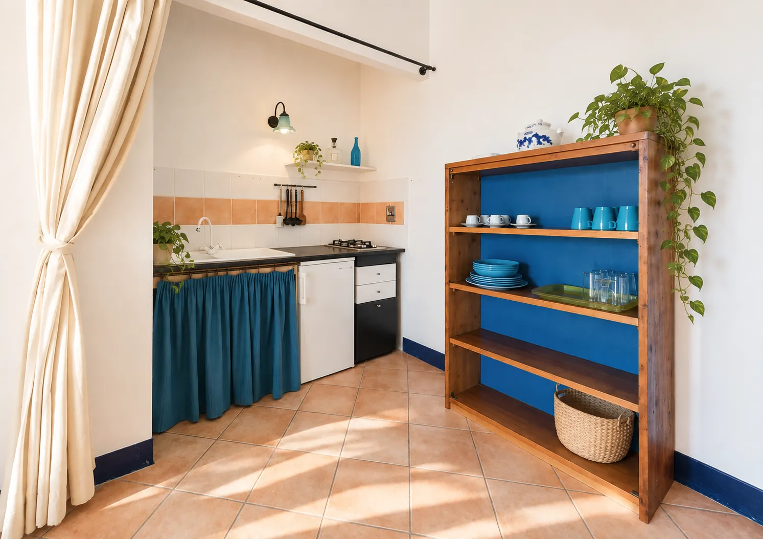 L’angolo cucina con la libreria in legno e le stoviglie azzurre